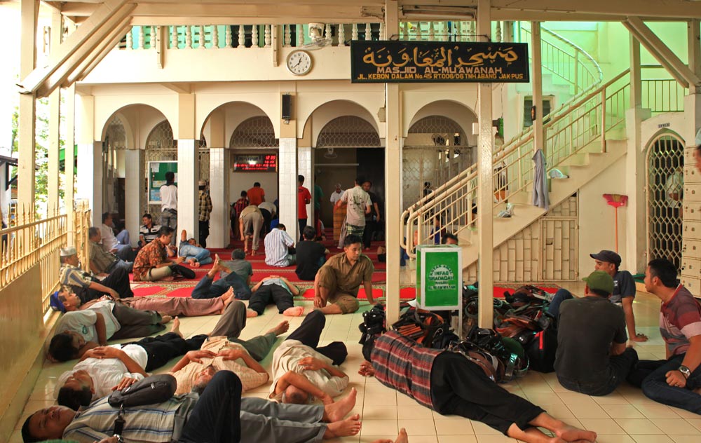 men sleeping inside a mosque in jakarta